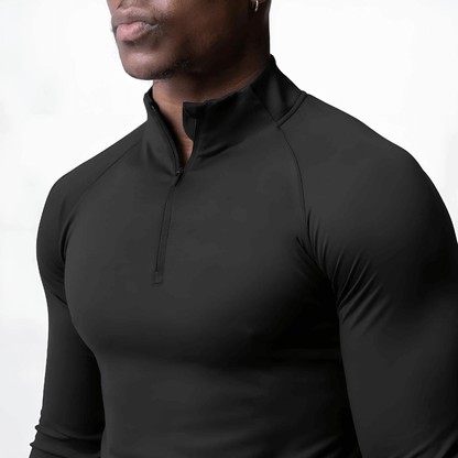 Close-up of a muscular man wearing a black Muscle V-Taper Quarter Zip men’s performance top.