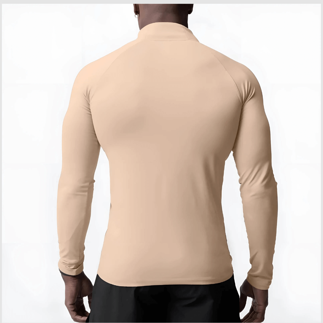 Back view of a man wearing a beige Muscle V-Taper Quarter Zip men’s performance top showcasing a sleek fit.
