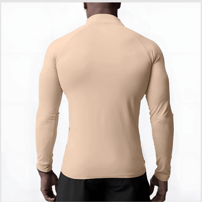 Back view of a man wearing a beige Muscle V-Taper Quarter Zip men’s performance top showcasing a sleek fit.