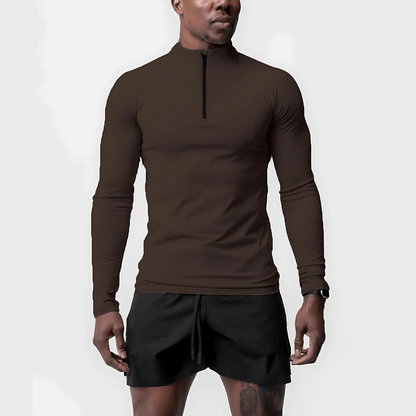 Man wearing Muscle V-Taper Quarter Zip men's performance top in brown, showcasing athletic fit and flexibility.